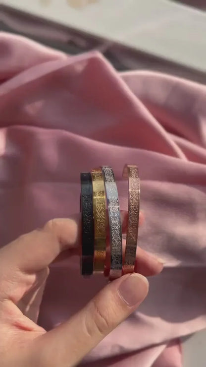 Islamic Ayat ul Kursi scripted bangle by Urbian Burj featuring intricate calligraphy on a sleek metal bracelet.