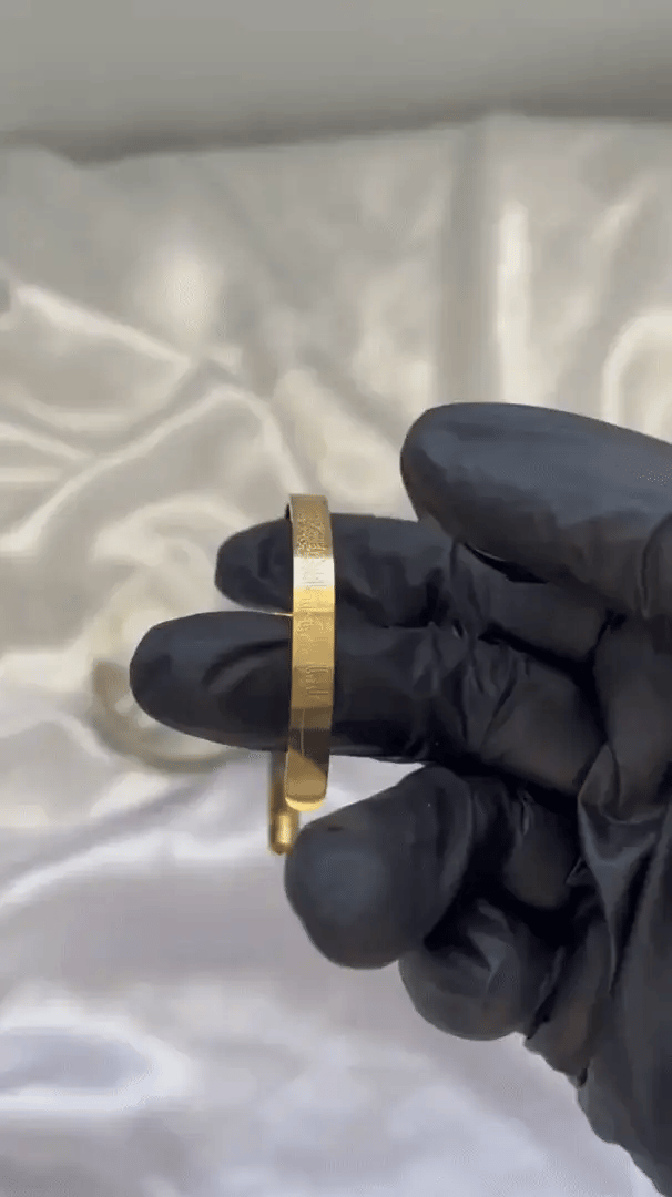 Islamic Ayat ul Kursi scripted bangle with intricate Arabic calligraphy, crafted by Urbian Burj, displayed on a neutral background.