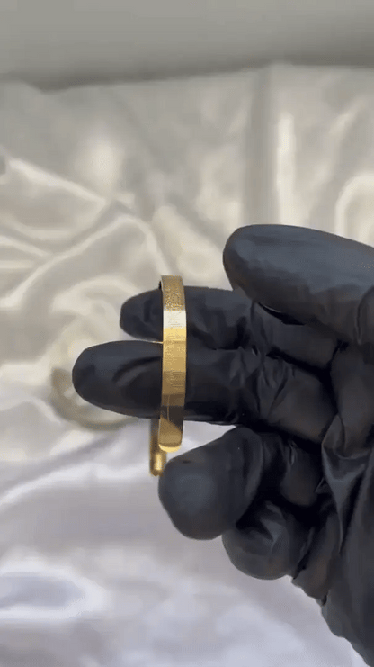 Islamic Ayat ul Kursi scripted bangle with intricate Arabic calligraphy, crafted by Urbian Burj, displayed on a neutral background.