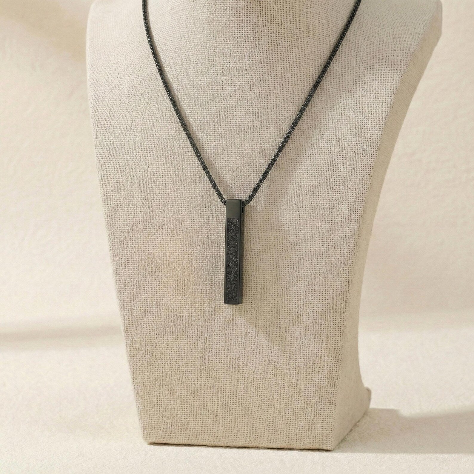 Urbian Burj Ayatul Kursi bar necklace featuring a sleek gold chain with engraved Quranic verse pendant.
