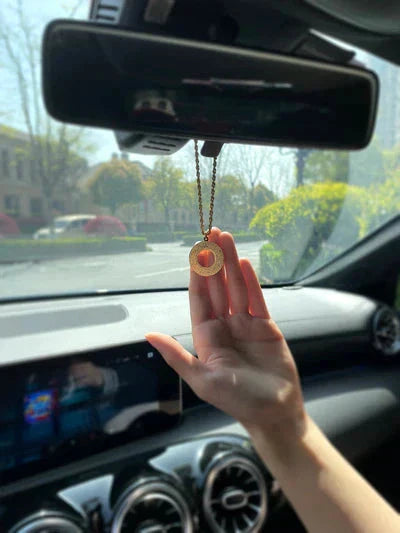 Urbian Burj DUA-Al-SAFAR round car hanger hanging from a vehicle's interior, designed for organizing small items in the car.